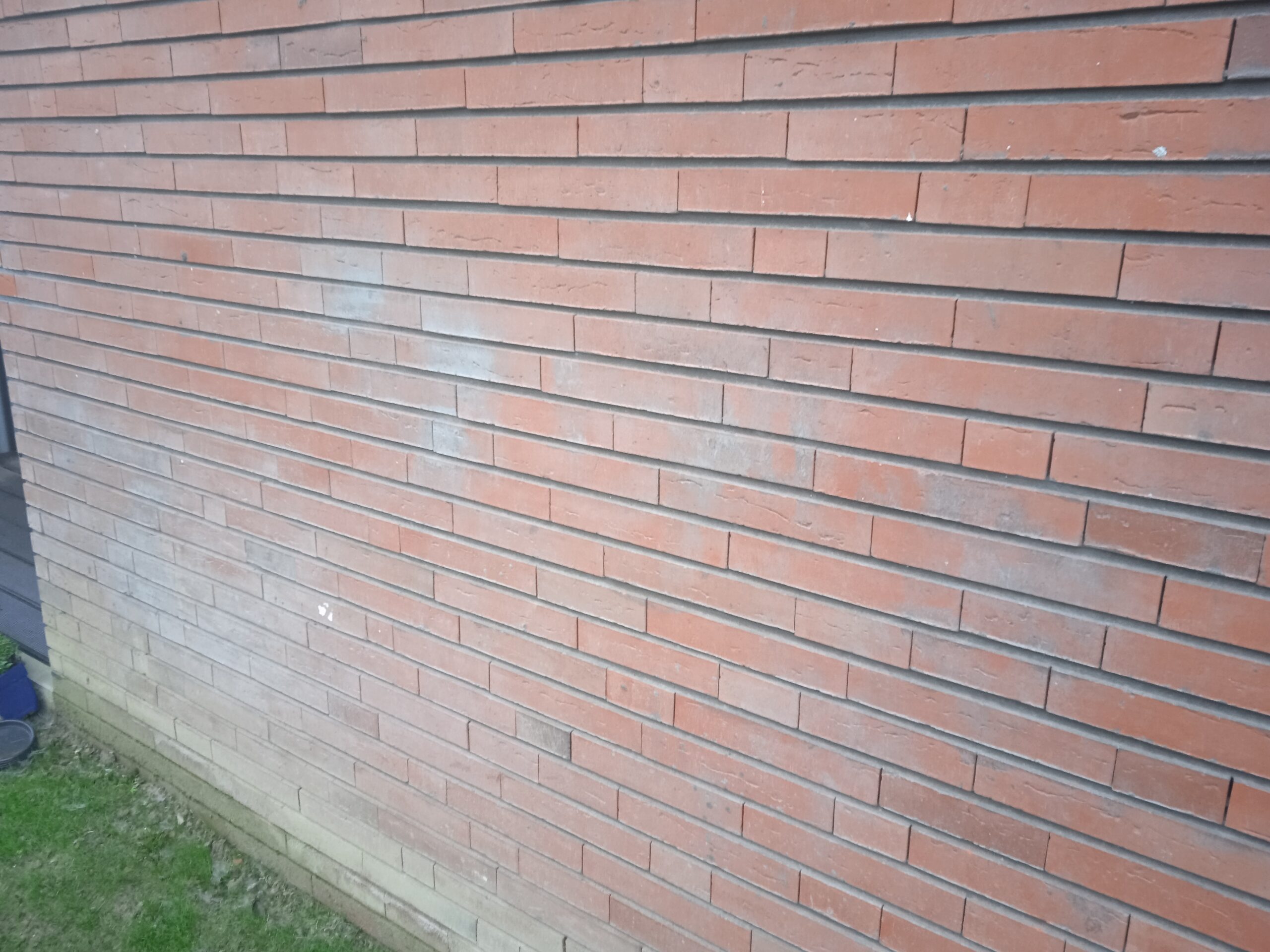 Cementstof op baksteengevel